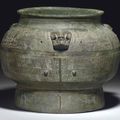 A rare and finely cast large ritual bronze wine vessel, pou, Shang dynasty, 11th century BC