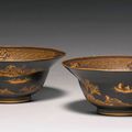 A rare pair of brown and gilt lacquer 'klapmuts' bowls, Qing dynasty, 18th century