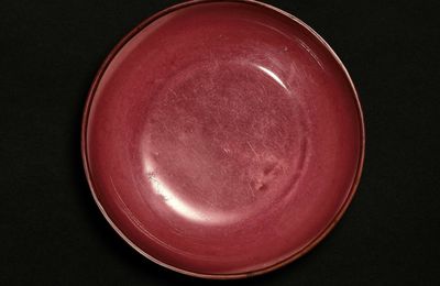 A rare red-glazed dish, Incised mark and period of Xuande