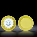 A fine pair of lemon yellow-enamelled dishes, Yongzheng six-character marks within double-circles and of the period (1723-1735)