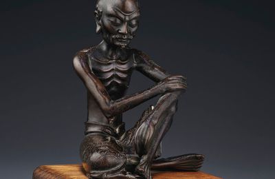 A silver-inlaid bronze figure of a seated Luohan, Ming-Qing dynasty, 17th century