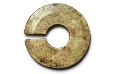 A calcified jade slit disc (Jue), Neolithic period-Shang dynasty