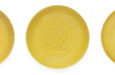 Three yellow-glazed incised 'dragon' saucer-dishes, Daoguang marks and of the period  & Guangxu mark and of the period