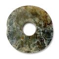 A mottled pale beige and green jade bi disc, 3rd millennium BC, Liangzhu culture