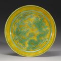 A yellow-ground green-enameled 'Dragon' dish, Jiajing mark and period (1522-1566)