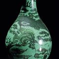 A green-ground black-decorated dragon bottle vase, China, Xuande six-character mark, 18th/19th century 