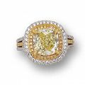 A cushion-shaped fancy yellow diamond and diamond ring