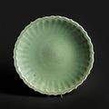 A fine and rare Longquan celadon-glazed 'double-peony' barbed-rim dish, Early Ming Dynasty, late 14th-early 15th century