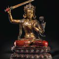 A magnificent and very rare large lacquered and gilt wood seated figure of Manjushri, Kangxi period (1662-1722)