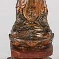 Bouddha en bois laqué or reposant sur un socle lotiforme. VIETNAM, XIXème siècle