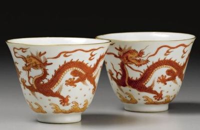 A pair of iron-red 'dragon' wine cups. Qianlong seal marks and period