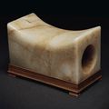 A mottled pale greenish-white and russet jade rectangular pillow, China, Ming dynasty (1368-1644) or later