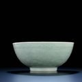 A large moulded celadon-glazed bowl, Qianlong six-character sealmark and of the period (1736-1795)
