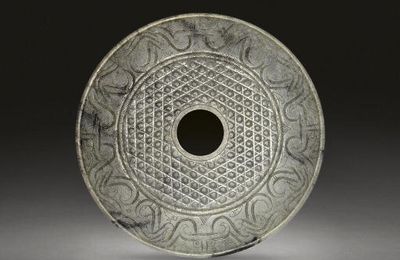 A large pale grey jade disc, bi, Han dynasty, 2nd-1st century BC 
