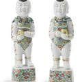A pair of Chinese Export porcelain rose-verte figures of boys, circa 1730