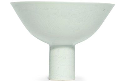 A white-glazed anhua-decorated 'dragon' stembowl, Qianlong mark and period