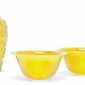 A pair of Chinese yellow glass wine cups and a carved yellow glass vase, 20th century