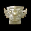 A finely carved ancient jade monster-like face, China, Late Neolithic period, around 2000 BC