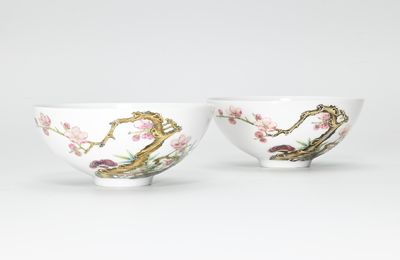 A fine and very rare pair of famille rose 'prunus and lingzhi' tea bowls, Yongzheng six character marks in underglaze blue within circles and of the period (1723-1735)