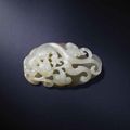 A pale green and russet jade 'chilong' pendant, 17th-18th century