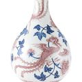 A blue and white and underglaze-red 'phoenix and peony' vase, Qing dynasty, 18th century