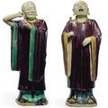 A large pair of glazed stoneware luohan, Ming dynasty  (1368-1644)