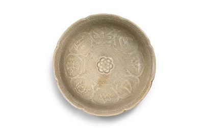 A rare lobed celadon 'auspicious objects' dish, Yuan dynasty