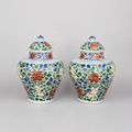 Pair of Chinese porcelain wucai baluster vases and covers, Shunzhi period, 1644-1661