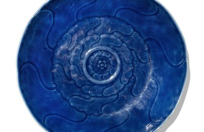 A carved blue-glazed dish, Qing dynasty, 18th century