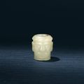 A yellow jade carving of a head, Shijiahe Culture, circa 2500-2000 BC