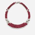 A diamond, platinum and 18K gold necklace set with oval shaped rubies weighing approximately 100 cts