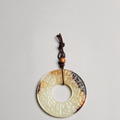 A white jade 'Cloud scroll' disc, yuan, Spring and Autumn period (770-476 BC)