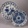 DELFT. Plat et Assiette en faïence à décor bleu, blanc de motifs floraux dans le gout de la Chine et rocaille stylisé. Fin XVIII