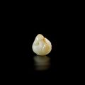 A pale green and russet jade 'phoenix' pendant, Ming Dynasty (1368-1644)