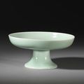 A pale-green-glazed carved 'lotus' stem dish, Qianlong seal mark and of the period