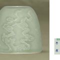A fine carved celadon-glazed waterpot, Kangxi six-character mark and of the period (1662-1722)