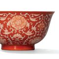 A coral-ground reserve-decorated ‘lotus’ bowl, Qianlong six-character seal mark in underglaze blue and of the period (1736-1795)