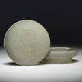 A rare Yueyao celadon carved and incised circlar box and cover. 10th century