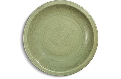 A large carved ‘Longquan’ celadon-glazed charger, Ming dynasty, 15th century