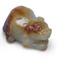 A carved white and russet jade dog pendant, Ming dynasty (1368-1644)