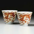 A pair of iron-red 'Dragon' wine cups, Jiaqing marks and period (1796-1820)
