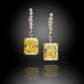 A pair of fancy colored diamond and diamond pendant earrings