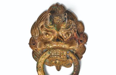 A gilt-bronze leonine mask-form fitting with loose ring, Northern Wei-Northern Qi dynasty, 6th century