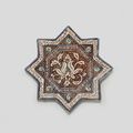 A Kashan lustre pottery star tile, Persia 13th-14th Century