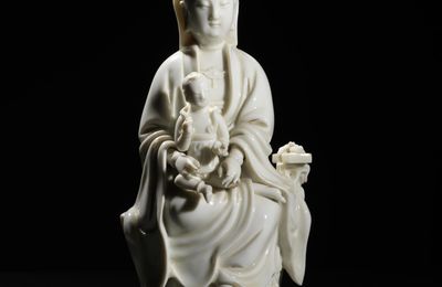 A blanc-de-chine Guanyin and child, 18th century