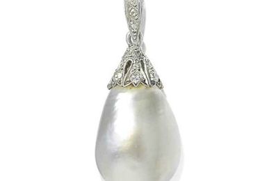 A slightly baroque drop-shaped natural pearl and diamond pendant, 1900s