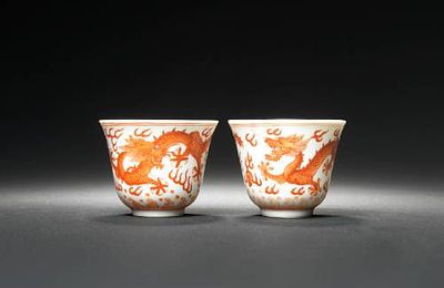 A pair of iron-red 'dragon' wine cups. Guangxu six-character marks and of the period