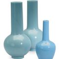 A pair of large pale blue glass bottle vases and a smaller bottle vase, 18th 19th century
