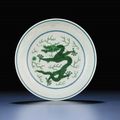 A very fine green-enamelled 'dragon' saucer dish, Qianlong six-character sealmark and of the period (1736-1795)