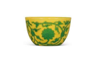 A fine and extremely rare carved yellow-ground green-enamelled ‘lotus’ wine cup, Yongzheng six-character mark in underglaze blue within a double circle and of the period (1723-1735)